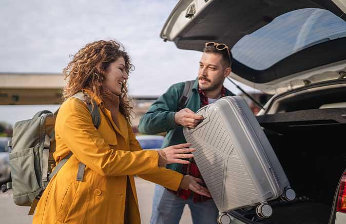 putting luggage into car