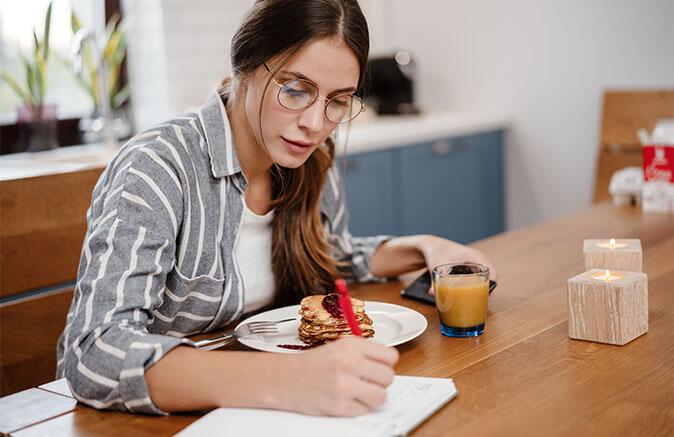 Woman writing down shopping list