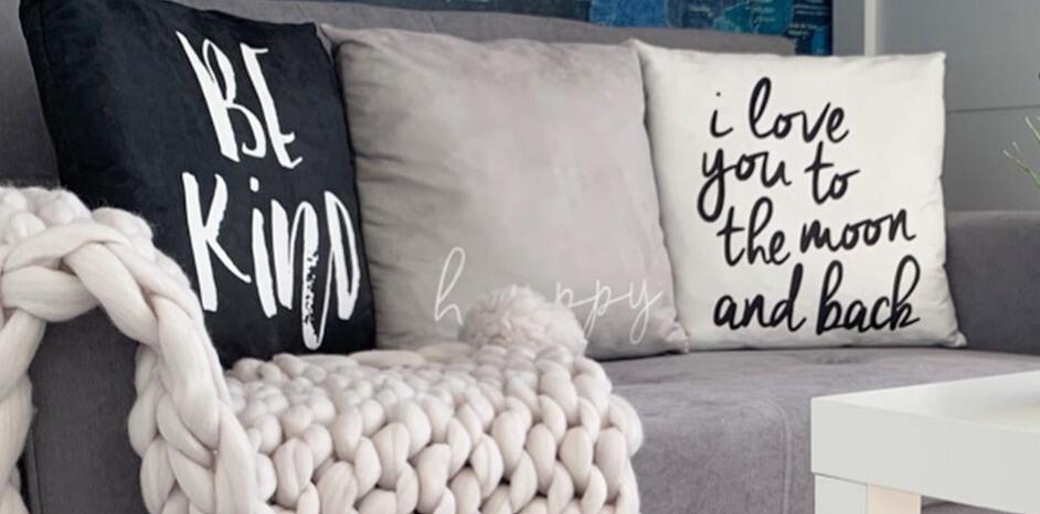 Iwantoneofthose deals page image featuring a grey sofa with cushions containing inspirational messages