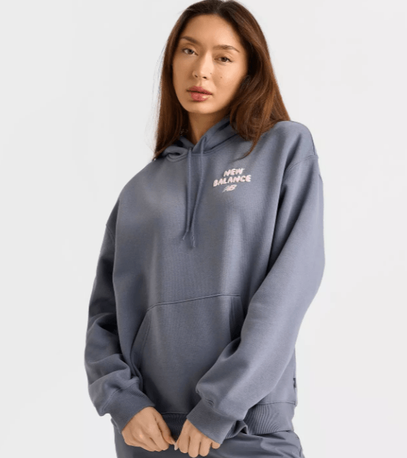 Woman wearing New Balance hoodie from JD Sports