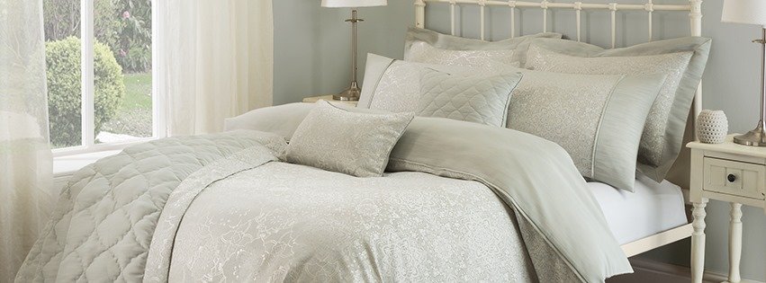 Julian Charles banner - bed made up with luxury Jualian Charles bedding, duvet set and pillows
