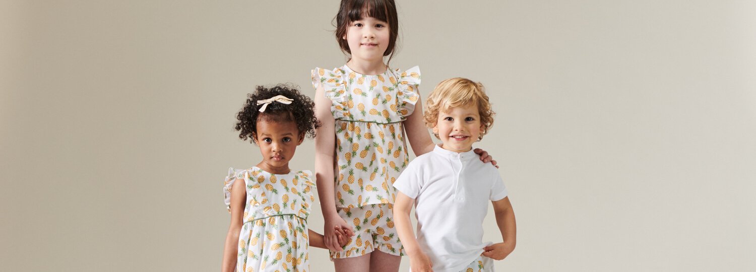 three children wearing designer kids&apos; clothing from La Coqueta