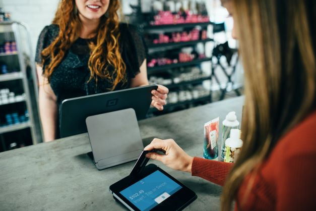 woman looking at clothes in shop