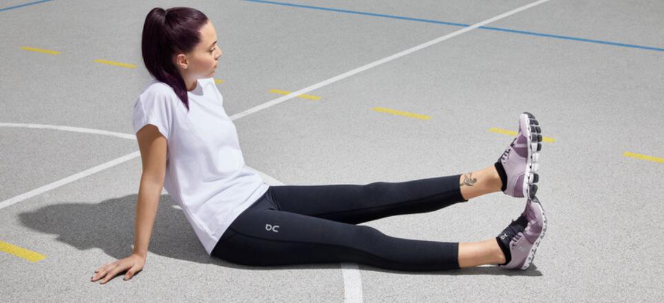 Legend Footwear offers page image - Woman sitting on the floor wearing white trainers