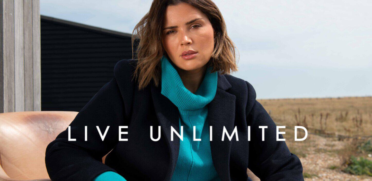 Live Unlimited savings banner showing a woman wearing warm styles with the company logo underneath