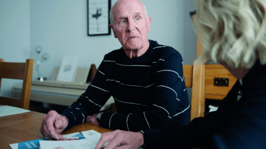 man with alzheimers getting support from a lady