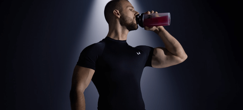 Myprotein winter banner - An athletic man drinking a protrein drink against a dark backdrop