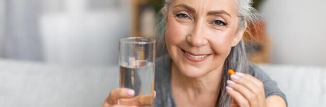 Nature’s Best viytamins image showing an elderly woman taking a vitamin