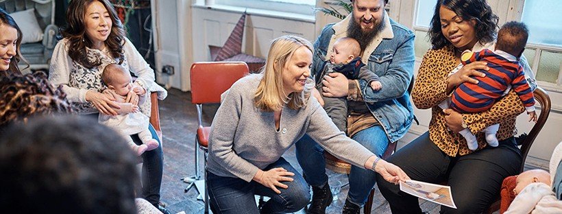 new parents with young babies in a community class or support group