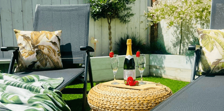 Online Home Shop garden living image showing garden recliners in outdoor setting