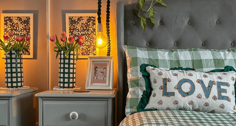 Online Home Shop savings page showing a view of a bedroom lit with warm lighting