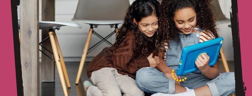 Two young girls using an iPad in an Otterbox iPad case