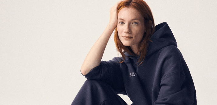 Pangaia offers page banner - Woman wearing a dark blue hoodie