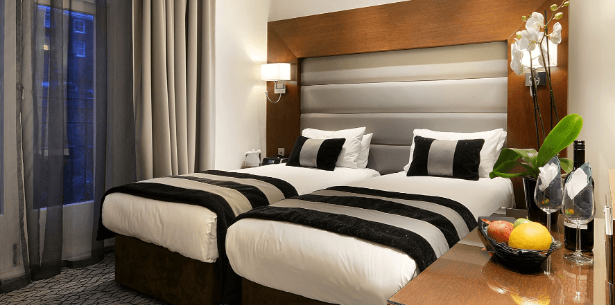 Park Grand London Hotels savings guide banner. Image shows a hotel room with bed as the main feature