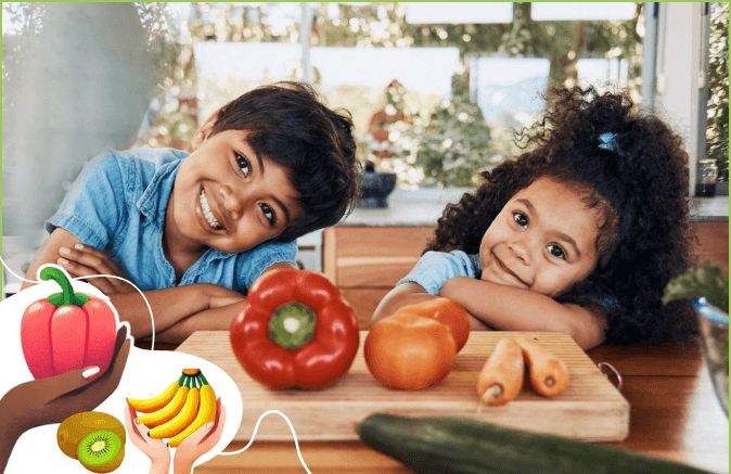 Smiling kids in a kitchen with fresh vegetables