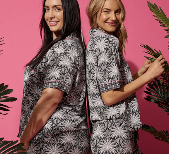 Two women wearing tropical pajamas from PJ Salvage in different sizes