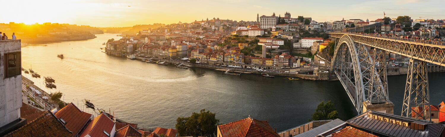 Porto holiday image showing a sunset view of the city from across the river.