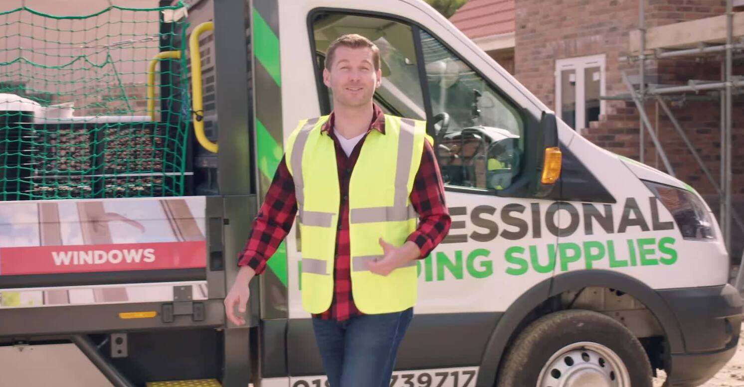 Professional Building Supplies offers page banner - Builder wearing a high vis jacket next to a van with company logo on side