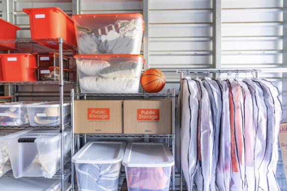 Public Storage storage unit with totes, boxes, and apparel