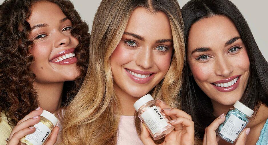 REHAB Your Hair offers page image - Three woman with shiny hair smiling and holding up branded packaging