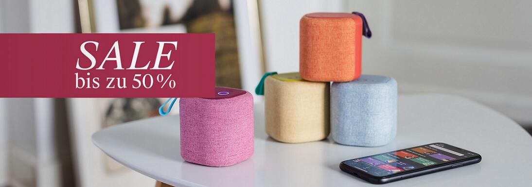 Banner mit bunten Lautsprecherboxen und Smartphone sowie dem Hinweis auf bis zu 50 % Rabatt im Remember Sale
