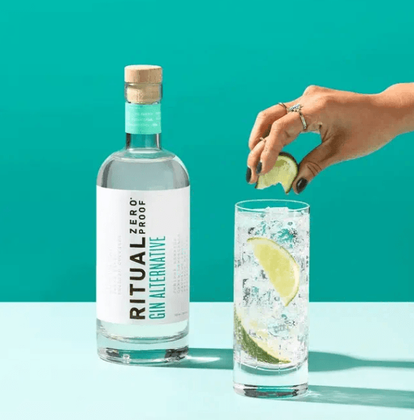 Ritual Zero Proof Gin Alternative in bottle and tall clear glass