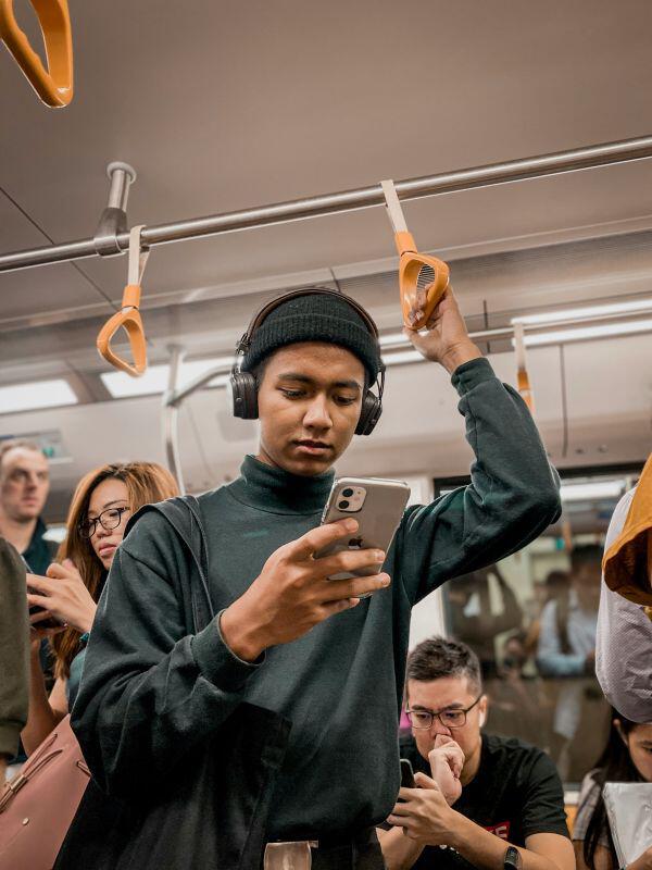 Person using phone with Roamless cell phone service on subway