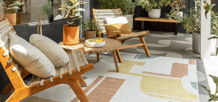 Ruggable better discount banner showing a patio with garden furniture sitting on a geometic yellow and cream rug