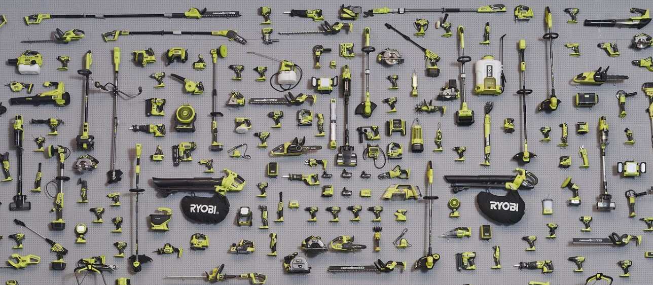 Ryobi how to get a better discount guide image featuring a huge assortment of Ryobi power tools on a grey background