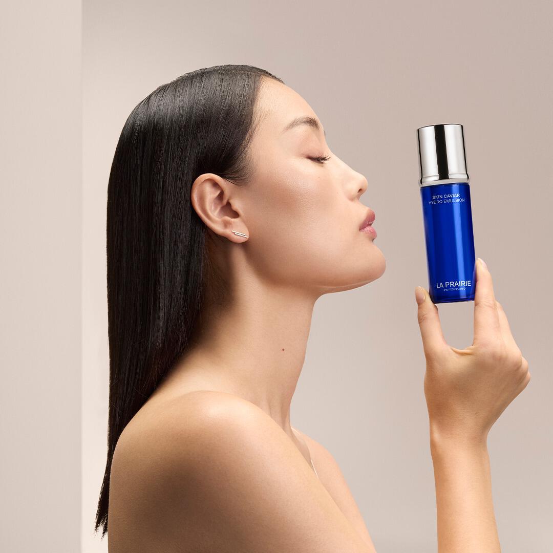 Woman holding La Prairie Serum from Sabina