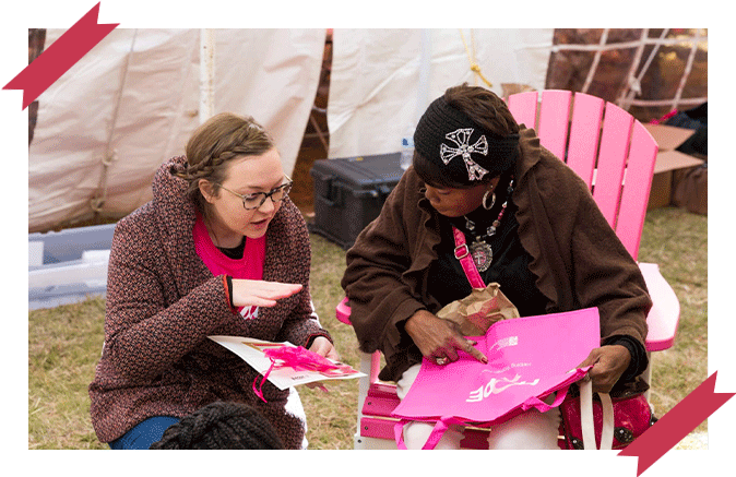 Two women having a conversation while wearing pink