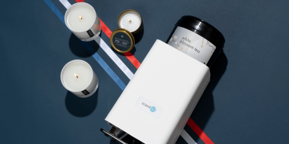 Scentair offers page banner - A Scentair device alonside candles against a navy backdrop with red stripe