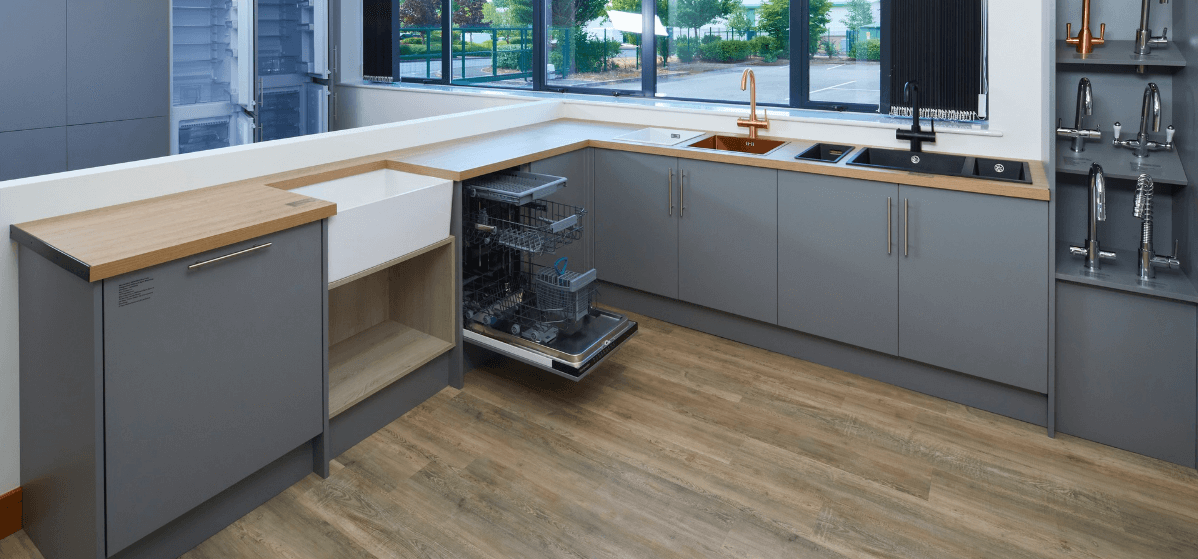 Ship It Appliances kitchen show room with tap, sink, and dishwasher