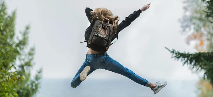 Shuperb deals page image - A woman jumping in the air wearing white trainers
