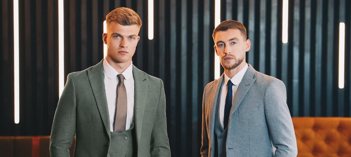 Slater Menswear offers page banner. Image features 2 men wearing grey suits in a bar