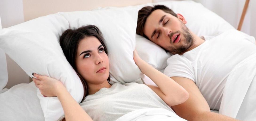 Sleeptest.co.uk savings page banner featuring a man and woman in bed with the female looking annoyed