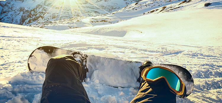 snowboarder sitting with blaur board shop gear