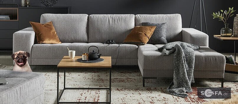 Eckcouch und Couchtisch als Banner der Sofa.de Gutscheinseite