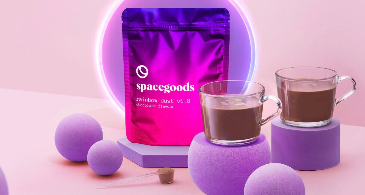 Spacegoods offers page banner showing a packet of rainbow dust with two transparent mugs containing the healthy drink