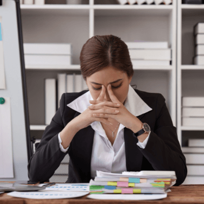 smart dressed woman looking stressed at work