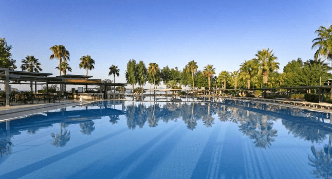 sunshine.co.uk more ways to save banner - A resort swimming pool with bright blue water and a cloud free sky