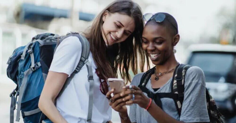 Superloop deals page banner showing two smiling woman looking at a mobile phone