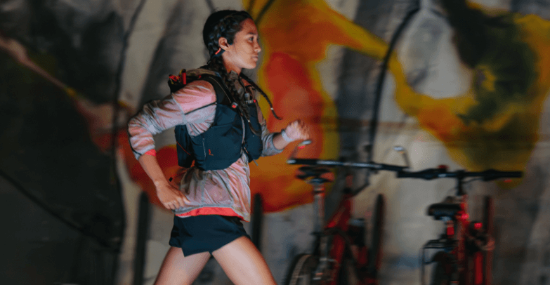 Suunto savings guide image - A woman power walking while wearing headphones and other Suunto gear