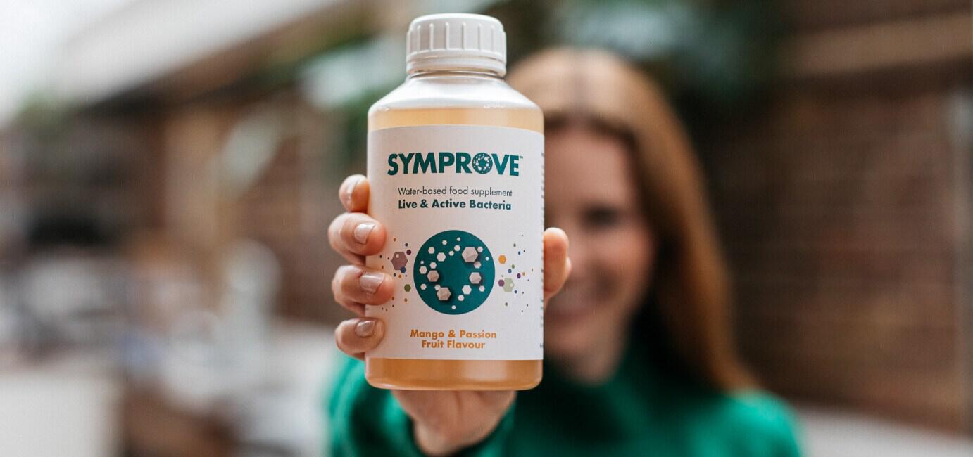 Symprove offers page image showing a woman holding up a food supplement bottle