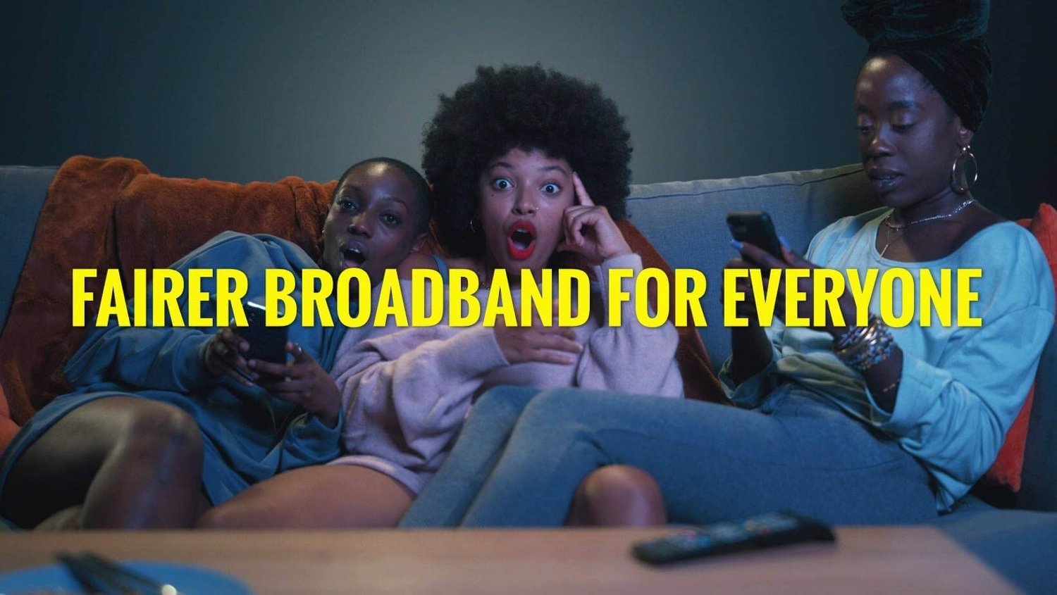 Three women sat on the sofa and watching television. Text reads: Fairer broadband for everyone