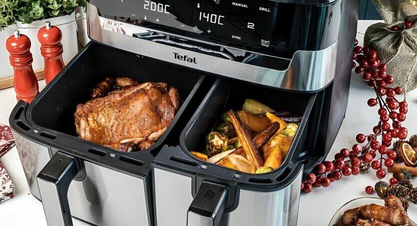 Tefal deals page image - A close up of an air fryer with open drawers containing food, including chicken