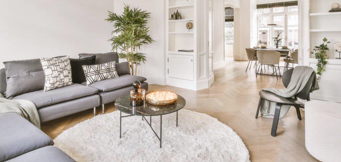 That Home Shop style inspiration image showing a modern spacious sitting room in muted colours with a grey sofa
