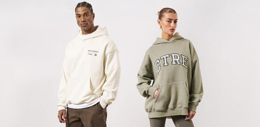 The Couture Club discounts page banner featuring a man and woman wearing natural coloured branded hoodies