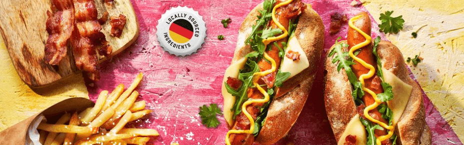 The Sausage Man banner image - bratwurst hotdogs with bacon and fries
