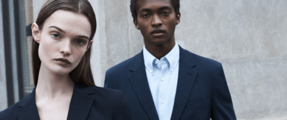 Theory offers page guide. Banner shows a man and woman wearing suits in front of a wall